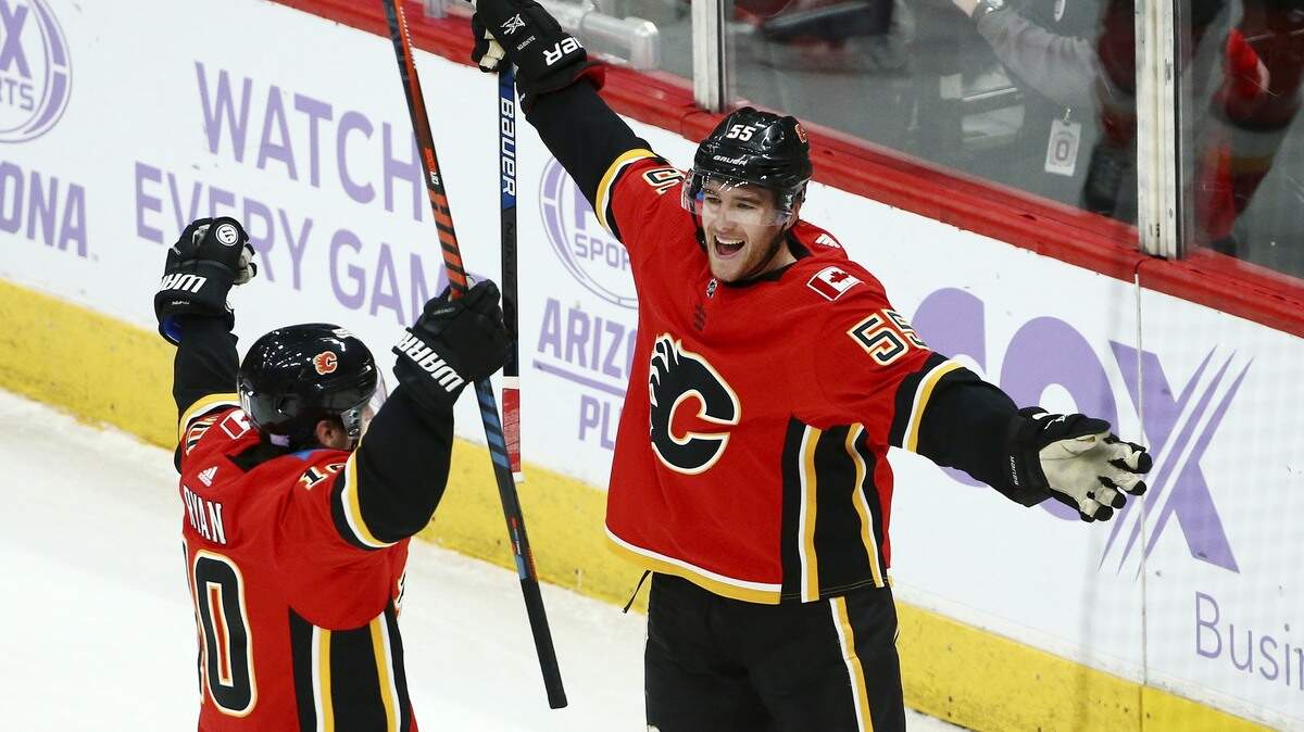 Calgary Flames defenseman Noah Hanifin (55) celebrates his goal against the Arizona Coyotes with center Derek Ryan (10) during the second period of an NHL hockey game Sunday, Nov. 25, 2018, in Glendale, Ariz. The Flames defeated the Coyotes 6-1. (AP Photo/Ross D. Franklin)
