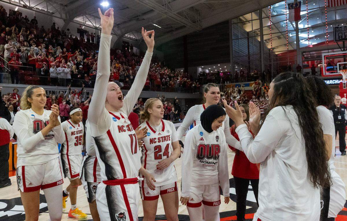 NC State’s freshman Maddie Cox (11) celebrates with teammates after the Wolpack’s 79-72 win against Tennessee during the second round of the Division I Women’s Basketball Championship at Reynolds Coliseum in Raleigh, on March 25, 2024. The Wolfpack won 79-72.