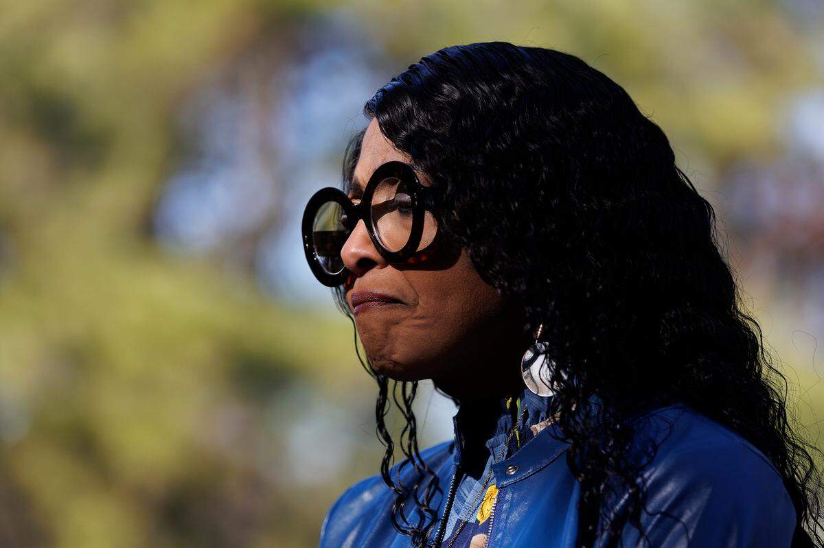 Gloria Williams, whose son Timothy Hall Jr. was killed in a 2022 crash near the Interstate-40 and Interstate-540 interchange, stands at the site of a roadside memorial on Friday, Feb. 7, 2025.