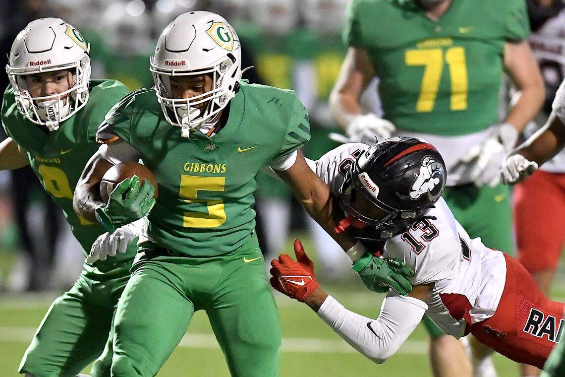 Cardinal Gibbons running back Kendall Scotton (5) rushes for yards against Rolesville’s Jovon Wright (13) during the first half. The Rolesville Rams and the Cardinal Gibbons Crusaders met in the East Regional Final of the NCHSAA 4A football playoffs in Raleigh, N.C. on December 13, 2024.