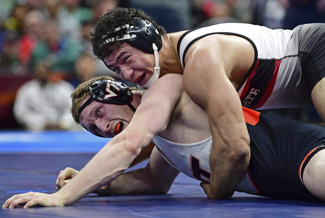 Virginia Tech's Jared Haught, bottom, and North Carolina State's Michael Macchiavello watch as the clock runs down during the 197-pound championship match of the NCAA Division I Wrestling Championships, Saturday, March 17, 2018, in Cleveland. Michael Macchiavello won the match.