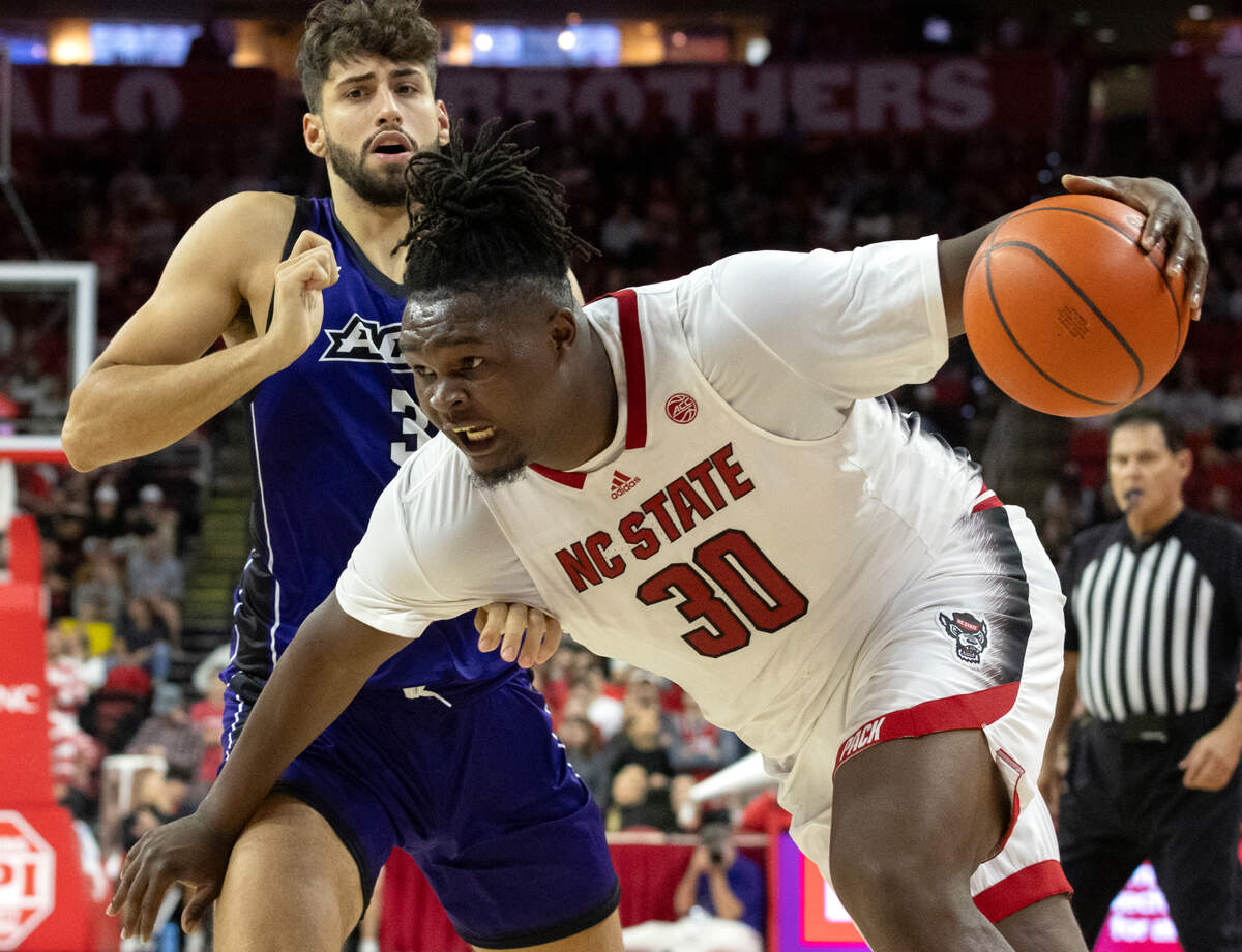 N.C. State’s DJ Burns Jr. pushes the ball past Abilene Christian’s Leonardo Bettiol during the second half of the Wolfpack’s 84-64 win on Friday, Nov. 10, 2023, at PNC Arena in Raleigh, N.C.