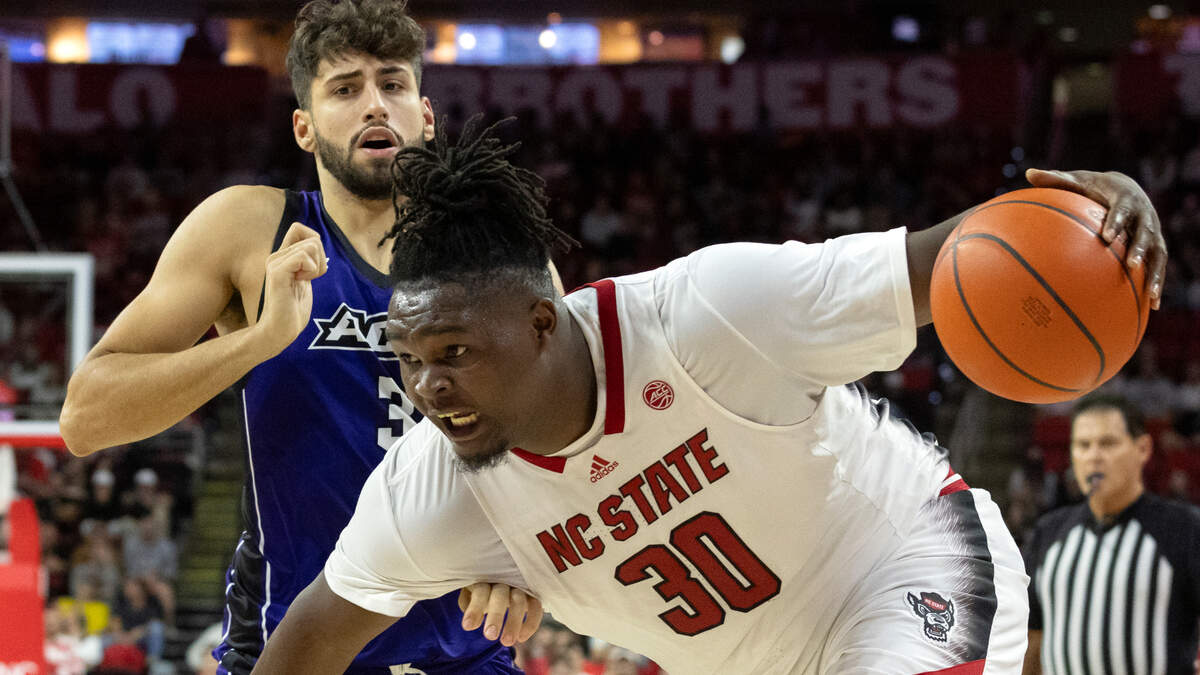 N.C. State’s DJ Burns Jr. pushes the ball past Abilene Christian’s Leonardo Bettiol during the second half of the Wolfpack’s 84-64 win on Friday, Nov. 10, 2023, at PNC Arena in Raleigh, N.C.