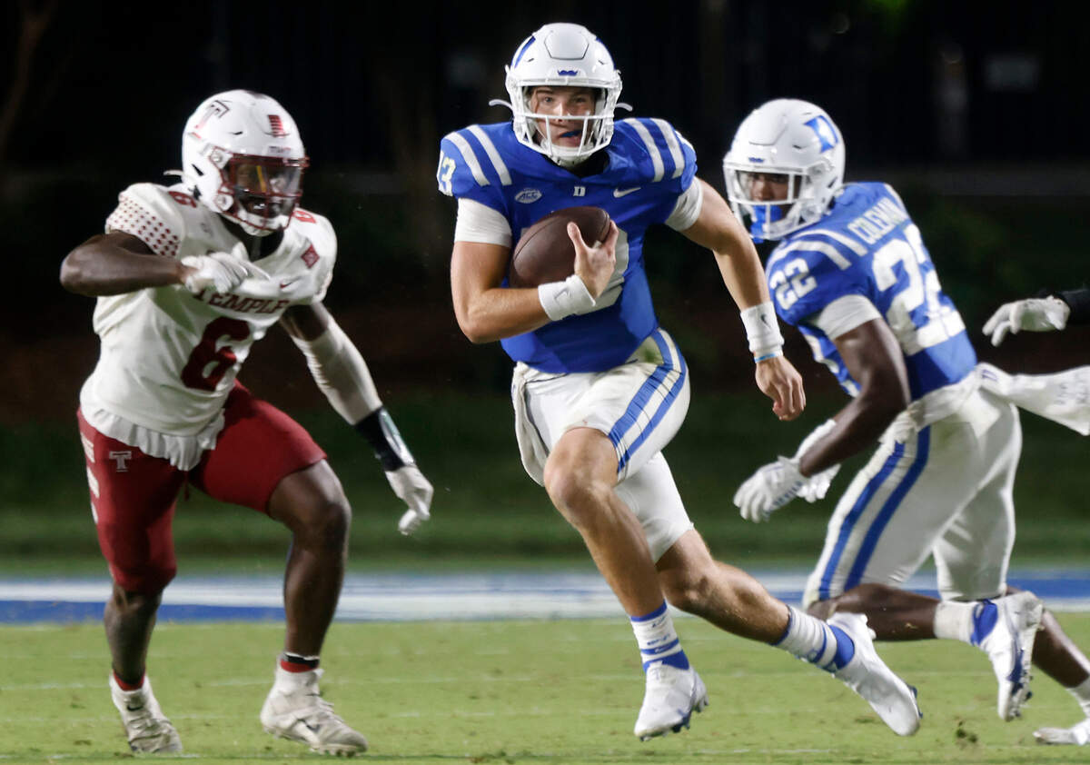 Duke quarterback Riley Leonard (13) runs the ball past Temple linebacker Jordan Magee (6) during the second half of the Blue Devilsí season opener at Wallace Wade Stadium on Friday, Sept. 2, 2022, in Durham, N.C. 