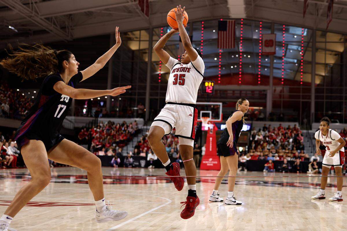 Zoe Brooks (35) of the N.C. State Wolfpack puts up a shot against Clara Silva of TCU in the first half at Reynolds Coliseum on Nov. 16, 2025 in Raleigh, North Carolina.