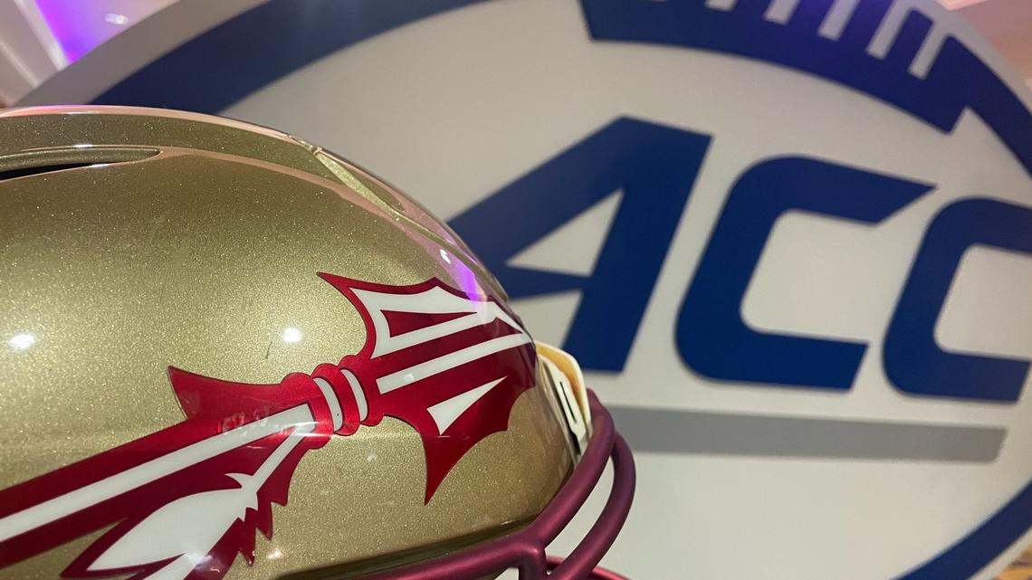 Florida State’s helmet sits next to the ACC logo at ACC football kickoff in Charlotte on Monday, July 22, 2024. The Seminoles are suing the ACC as the league’s annual media days begin.