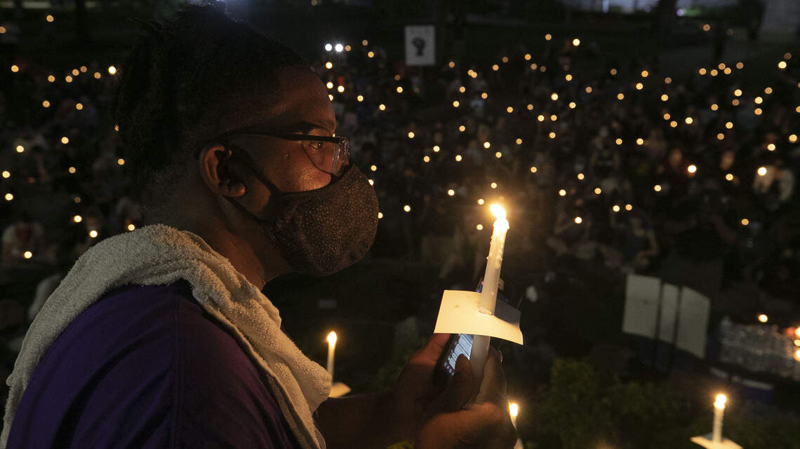 Raleigh protesters hold candlelight vigil after visiting site of 2016 shooting by police