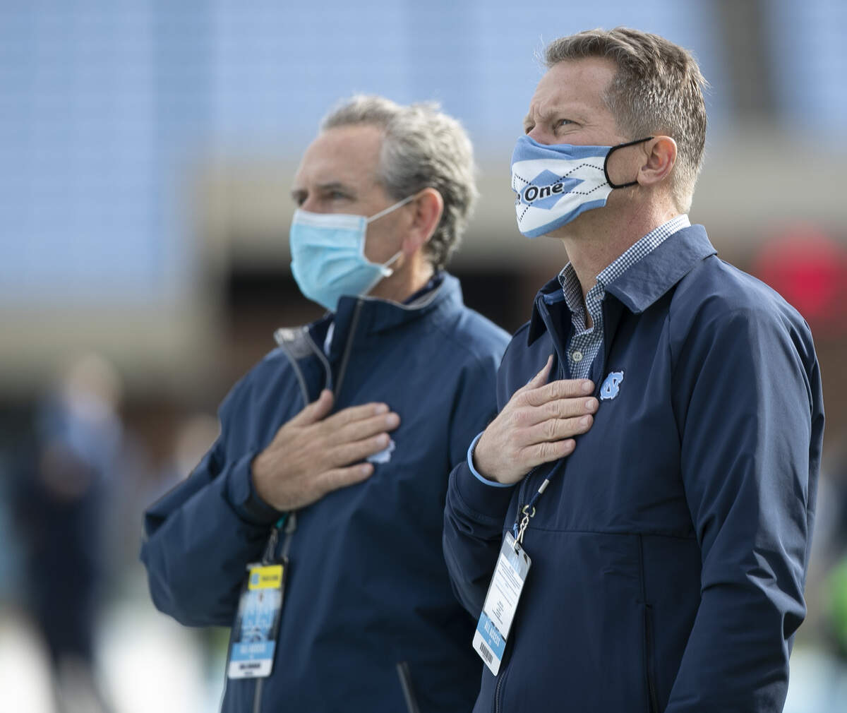 North Carolina chancellor Kevin Guskiewicz and athletic director Bubba Cunningham stand for the National Anthem prior to the Tar Heels’ game against Western Carolina on Saturday, December 5, 2020 at Kenan Stadium in Chapel Hill, N.C.