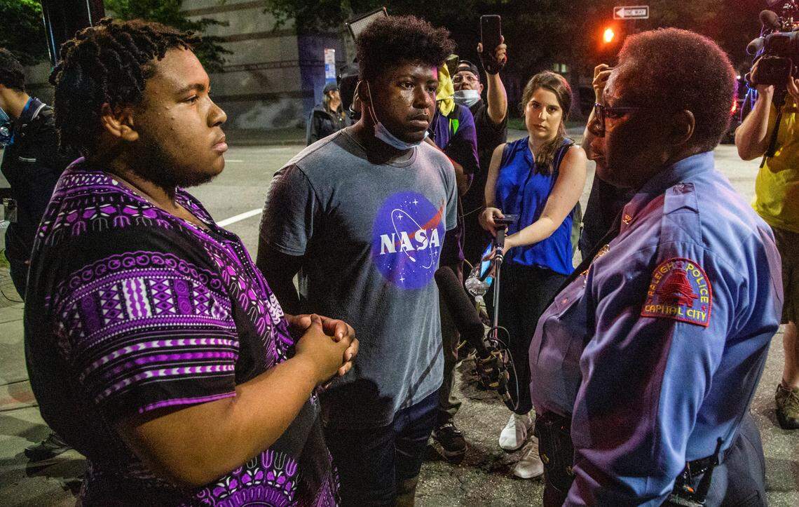 Raleigh Police Chief Cassandra Deck-Brown, right, talks with protesters Bryant E Riddick II, left, and Joseph Mbemba who were among a group breaking curfew in Raleigh Wednesday, June 3, 2020. Deck-Brown allowed protesters to march until 9:45 p.m. on the condition that they would disperse and return to their homes.