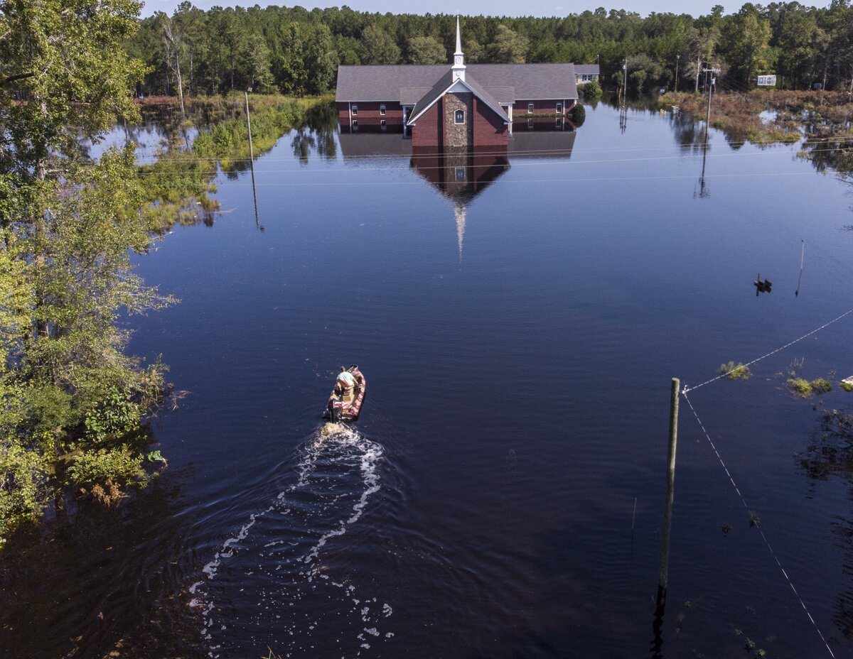 Avery Singleton takes a boat to Pine Grove Baptist Church in Brittons Neck. Residents of Brittons Neck in Marion County are nearing the crest the flooding from the Little Pee Dee River on Saturday, but many are concerned that the flooding Great Pee Dee will increase damage to their community. Sept. 22, 2018.