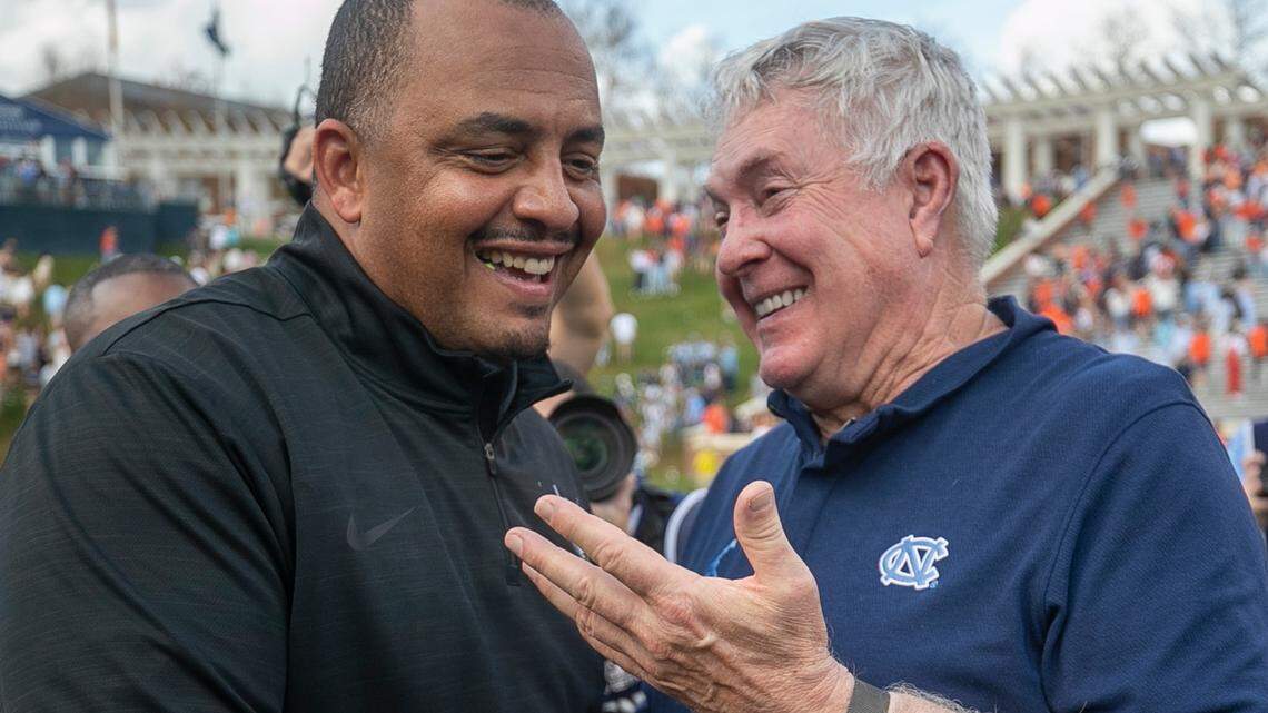 Virginia coach Tony Elliott congratulates North Carolina coach Mack Brown following the Tar Heels’ 31-28 victory on Saturday, November 5, 2022 at Scott Stadium in Charlottesville, Va.