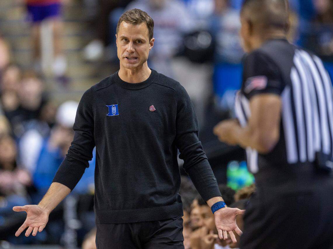 Duke coach Jon Scheyer questions official Tim Valentine during the Blue Devils’ game against Miami on Friday, March 10, 2023 at the Greensboro Coliseum in Greensboro, N.C.