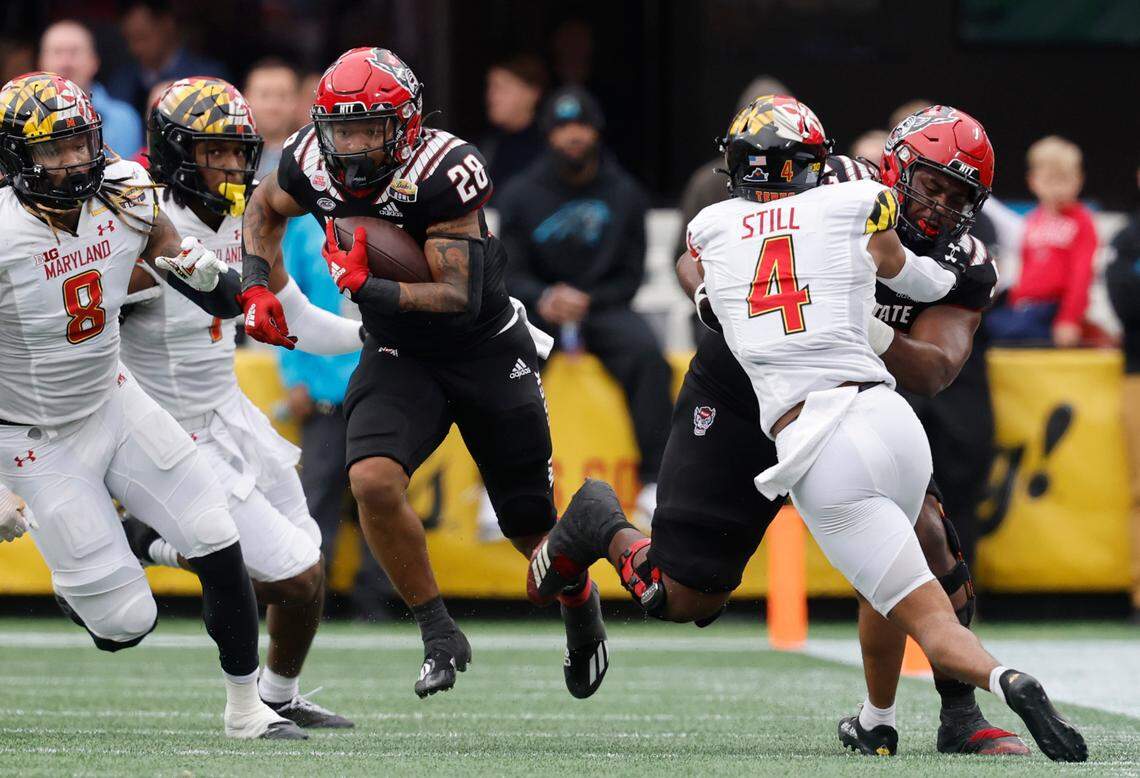 N.C. State offensive lineman Lyndon Cooper (57) blocks Maryland defensive back Tarheeb Still (4) to give N.C. State running back Demarcus Jones II (28) space to run during the second half of Maryland’s 16-12 victory over N.C. State in the Duke’s Mayo Bowl at Bank of America Stadium in Charlotte, N.C., Friday, Dec. 30, 2022.
