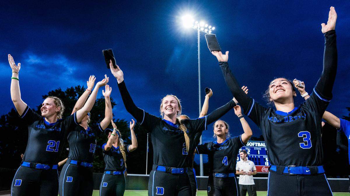 Duke’s softball players Julia Boyet (21), Lillie Walker (15), Claire Davidson (7), Jameson Kavel (2), Ana Gold (4) and Kelly Torres (3) celebrate the team’s NCAA regional championship on Sunday, May 22, 2022, in Durham.