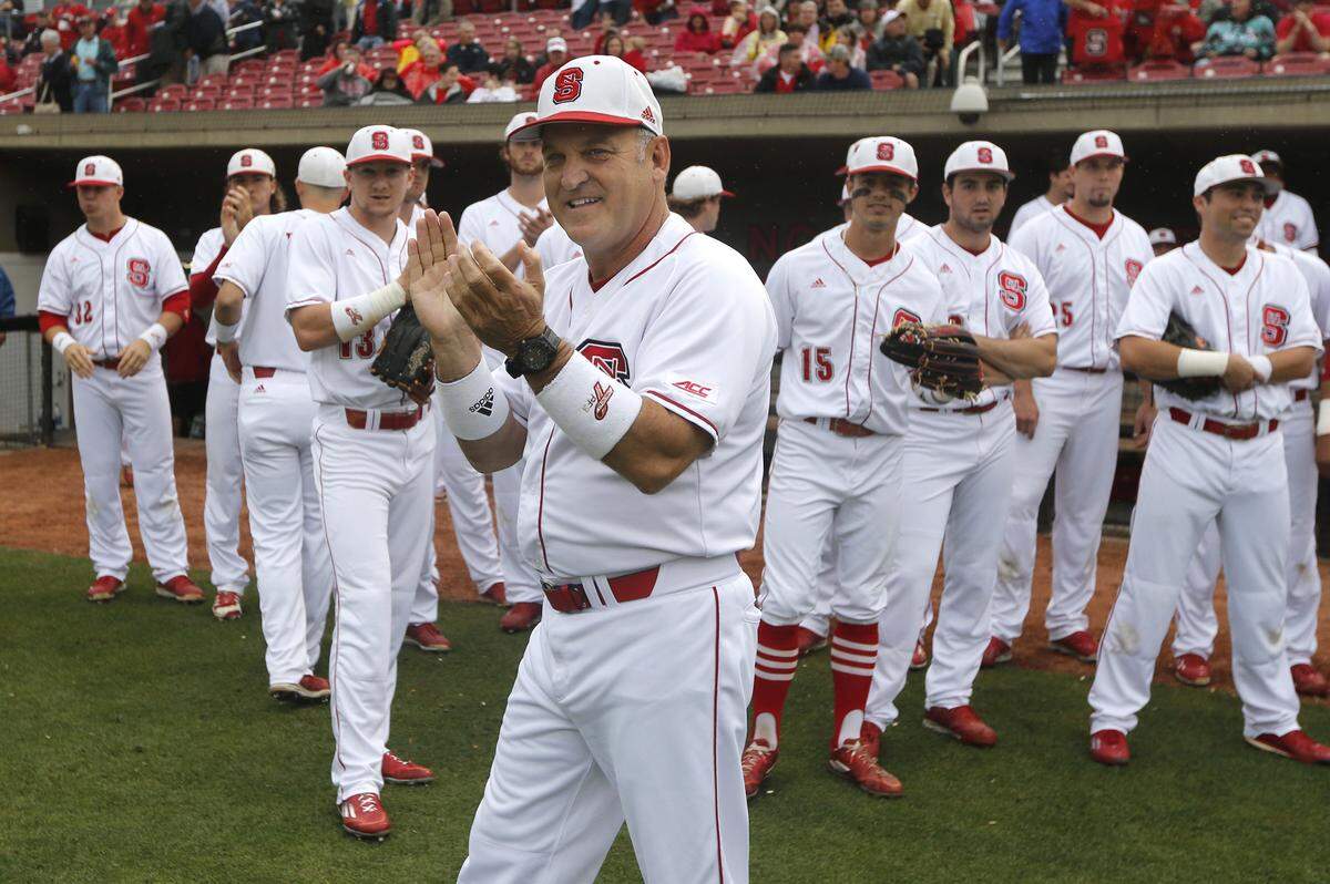 N.C. State head coach Elliott Avent and the team watch pregame activities before the Wolfpack's game against UNC at Doak Field in Raleigh, N.C., Friday, May 20, 2016.