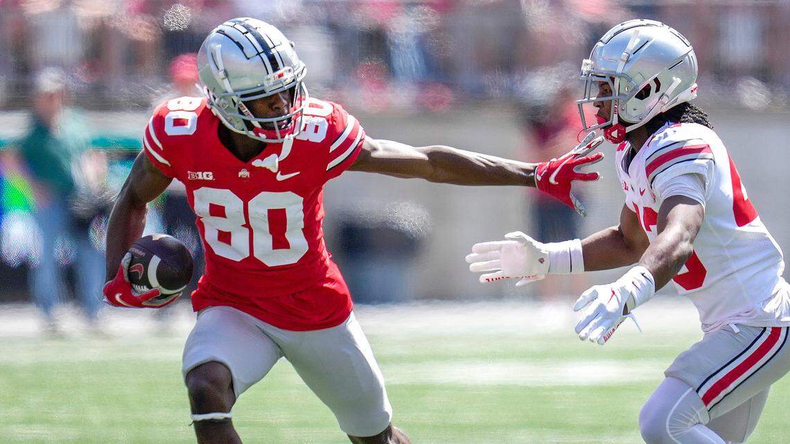 Ohio State Buckeyes wide receiver Noah Rogers (80) evades Ohio State Buckeyes cornerback Diante Griffin (43) during their spring game at Ohio Stadium in April 2023.