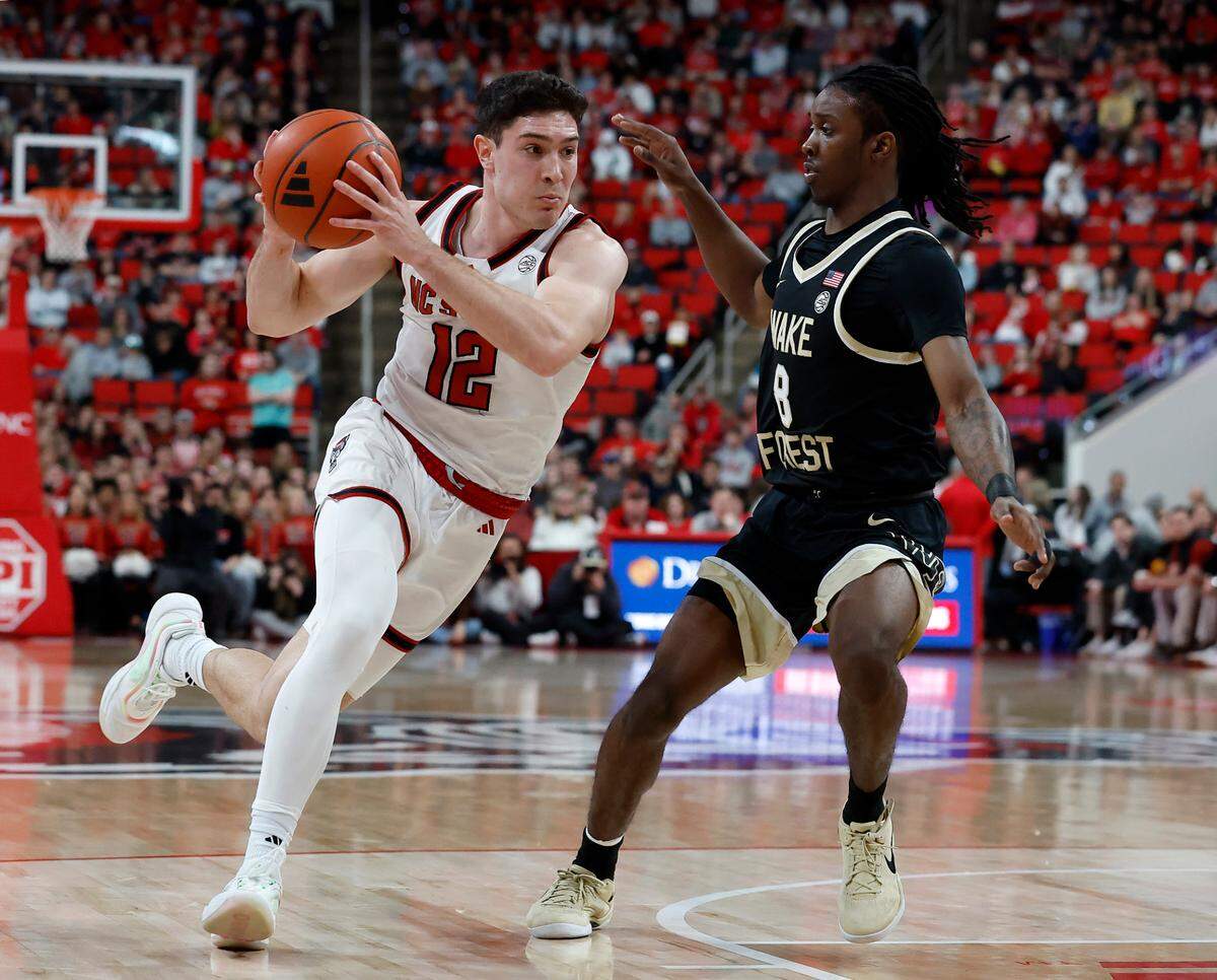 N.C. State’s Michael O’Connell drives past Wake Forest’s Ty-Laur Johnson during the first half of the Wolfpack’s 85-73 win on Saturday, Feb. 22, 2025, at Lenovo Center in Raleigh, N.C.