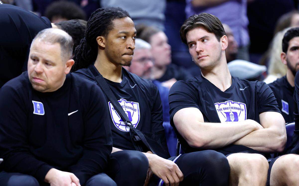 Duke’s Maliq Brown sits on the bench with Neal Begovich during the second half of Duke’s 80-62 victory over Virginia at John Paul Jones Arena in Charlottesville, Va., Monday, Feb. 17, 2025.