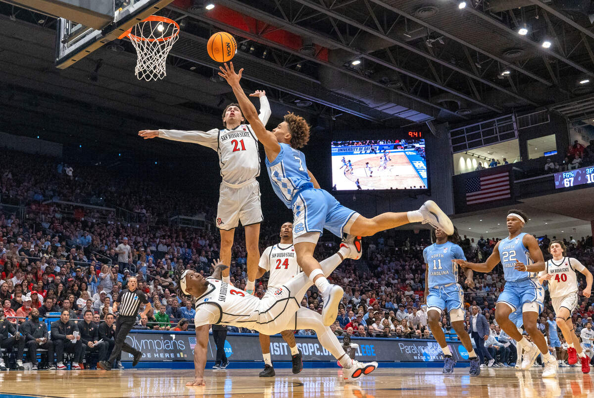North Carolina guard Seth Trimble (7) drives to the basket against San Diego State’s Wayne McKinney III (3) and Miles Byrd (21) in the first half during the NCAA First Four on Tuesday, March 18, 2025 at the University of Dayton Arena in Dayton, Ohio.