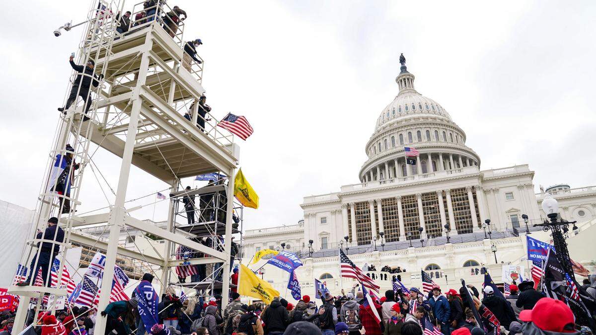 Supporters loyal to President Donald Trump clash with authorities before successfully breaching the Capitol building during a riot on the grounds, Wednesday, Jan. 6, 2021. A number of lawmakers and then the mob of protesters tried to overturn America’s presidential election, undercutting the nation’s democracy by attempting to keep Democrat Joe Biden from replacing Trump in the White House.