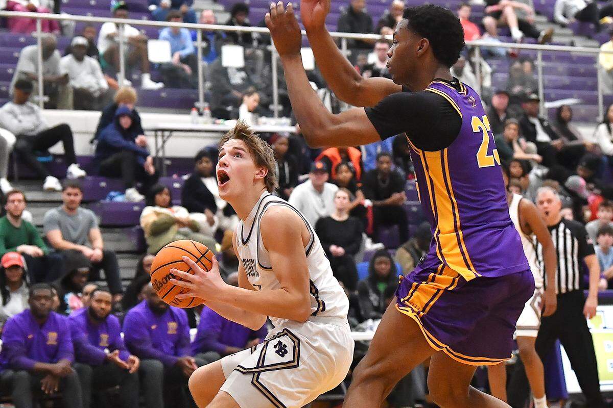 Broughton's Brayden Tuttle (2) looks to shoot against Wilson's Josh Leonard (23) during the first half. The Broughton Capitals and the Wilson (SC) Tigers played in the first round of the John Wall Holiday Tournament on December 26, 2025.