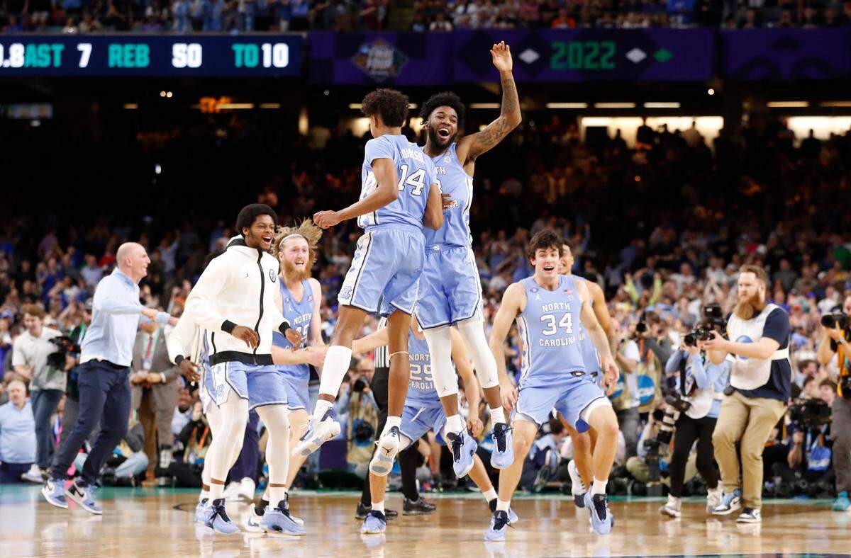 North Carolina’s Dontrez Styles (3) and Puff Johnson (14) celebrate after UNC’s 81-77 victory over Duke in the Final Four at Caesars Superdome in New Orleans, La., Saturday, April 2, 2022.