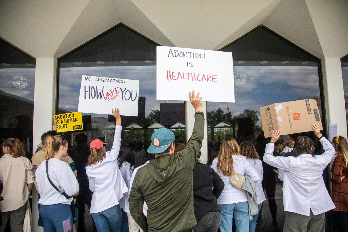 Demonstrators hold signs outside the legislature auditorium where a House Rules meeting&nbsp;was underway, May 3, 2023 at the Legislative Building. Republican state lawmakers announced their plan to limit abortion rights across the state.