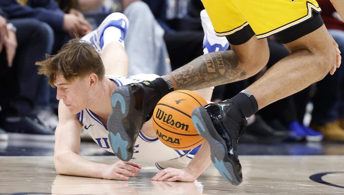 Duke’s Nikolas Khamenia (14) dives after the loose ball during the first half of Duke’s game against Michigan in the Capital Showcase at Capital One Arena in Washington, D.C., Saturday, Feb. 21, 2026.