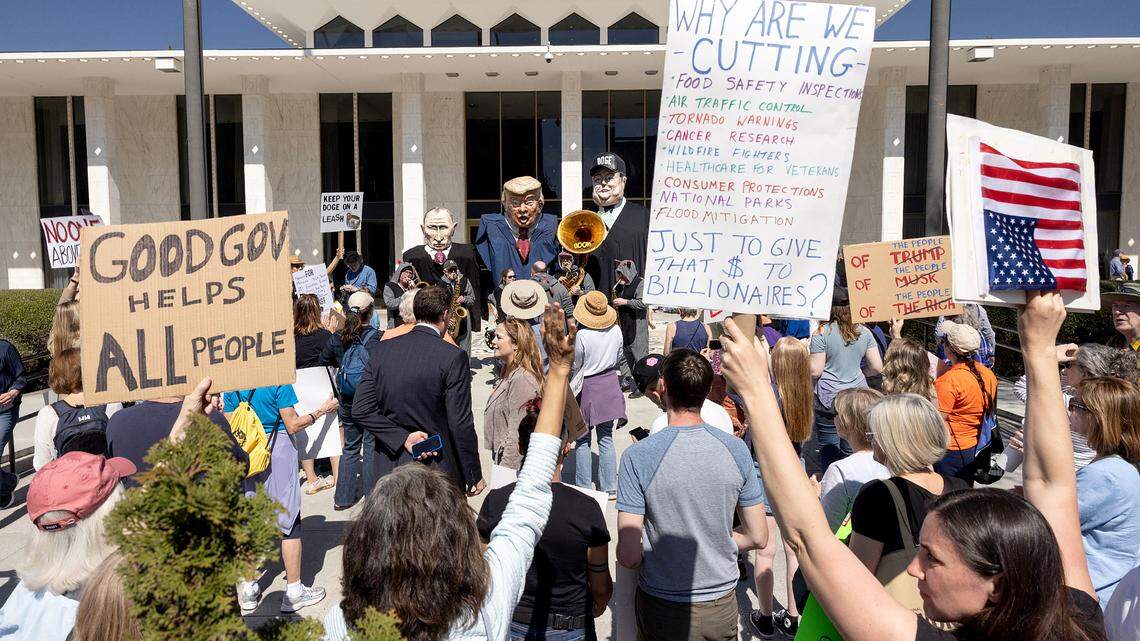 Protesters opposed to cuts and actions by DOGE and Elon Musk rally outside of the N.C. Legislature, Wednesday, March 12, 2025.