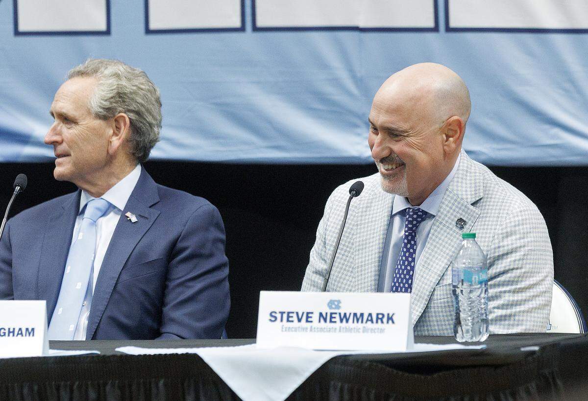 Incoming North Carolina athletic director Steve Newmark smiles as new men’s basketball head coach Michael Malone speaks during a press conference at the Smith Center on Tuesday, April 7, 2026, in Chapel Hill, N.C. 