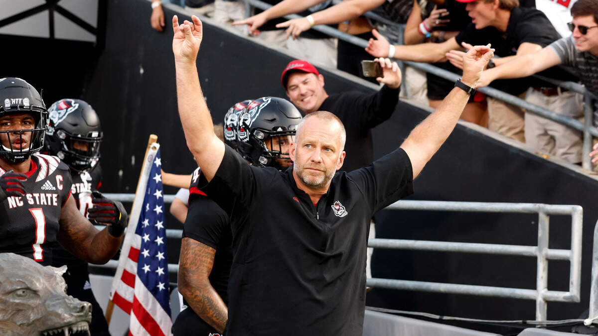 N.C. State head coach Dave Doeren acknowledges the crowd as he leads the team out onto the field before the Wolfpack’s game against Texas Tech at Carter-Finley Stadium in Raleigh, N.C., Saturday, Sept. 17, 2022.