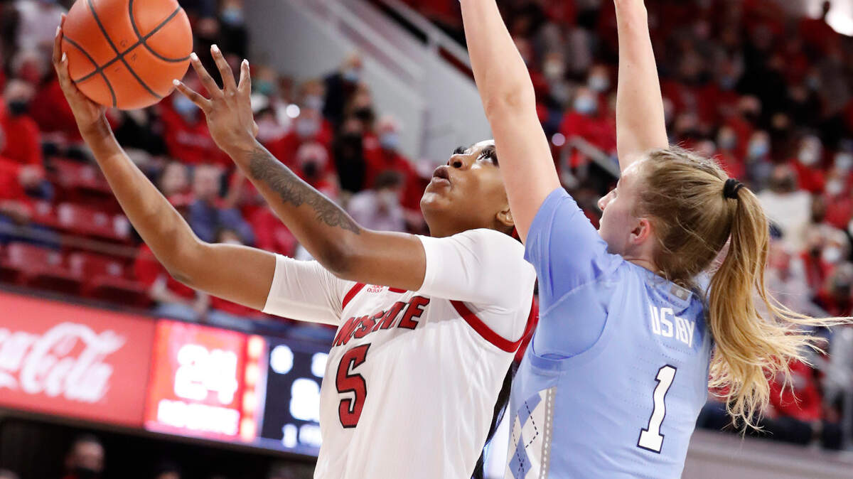 N.C. State’s Jada Boyd (5) shoots as North Carolina’s Alyssa Ustby (1) defends during the first half of N.C. State’s game against UNC at Reynolds Coliseum in Raleigh, N.C., Thursday, January 6, 2022.