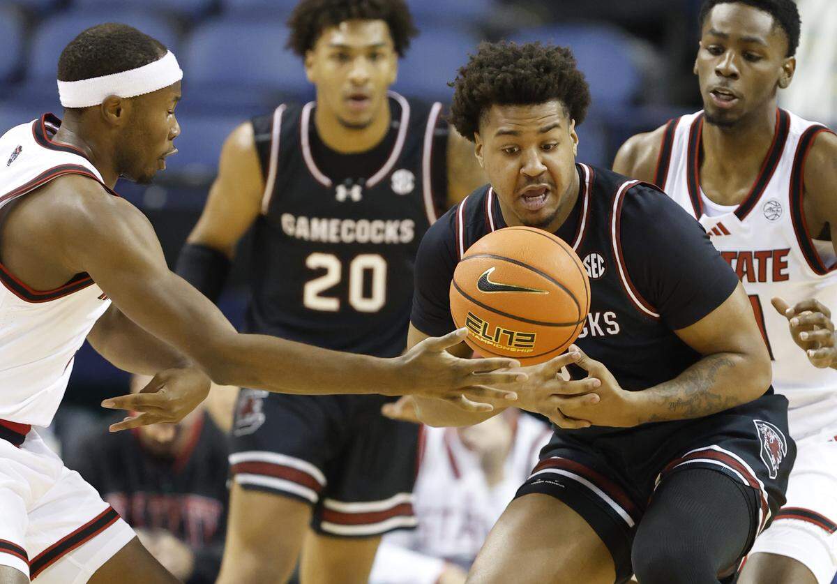 South Carolina's Elijah Strong (31) tries to pull in the loose ball from N.C. State's Tre Holloman (5) during the first half of  N.C. State’s exhibition game against South Carolina at the First Horizon Coliseum in Greensboro, N.C., Sunday Oct. 26, 2025.