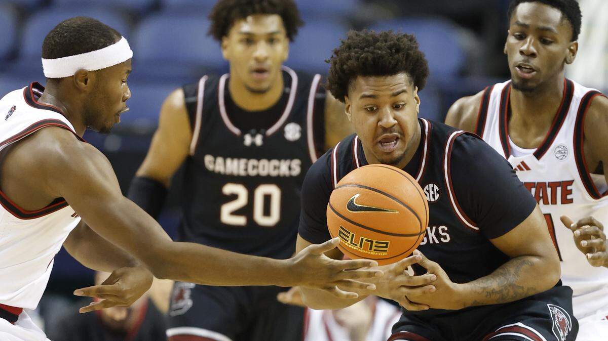 South Carolina's Elijah Strong (31) tries to pull in the loose ball from N.C. State's Tre Holloman (5) during the first half of N.C. State’s exhibition game against South Carolina at the First Horizon Coliseum in Greensboro, N.C., Sunday Oct. 26, 2025.