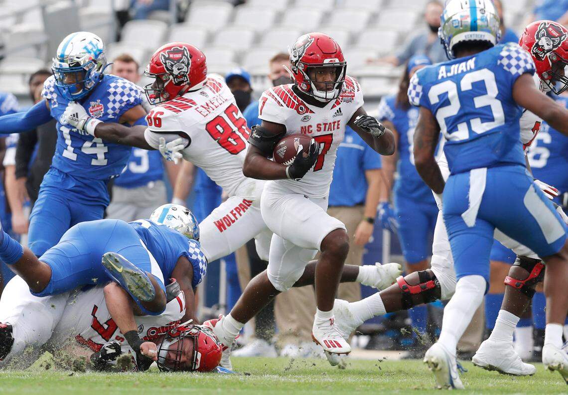 N.C. State running back Zonovan ‘Bam’ Knight (7) gains yards during the second half of Kentucky’s 23-21 victory over N.C. State in the Gator Bowl at TIAA Bank Field in Jacksonville, Fla., Saturday, January 2, 2021.