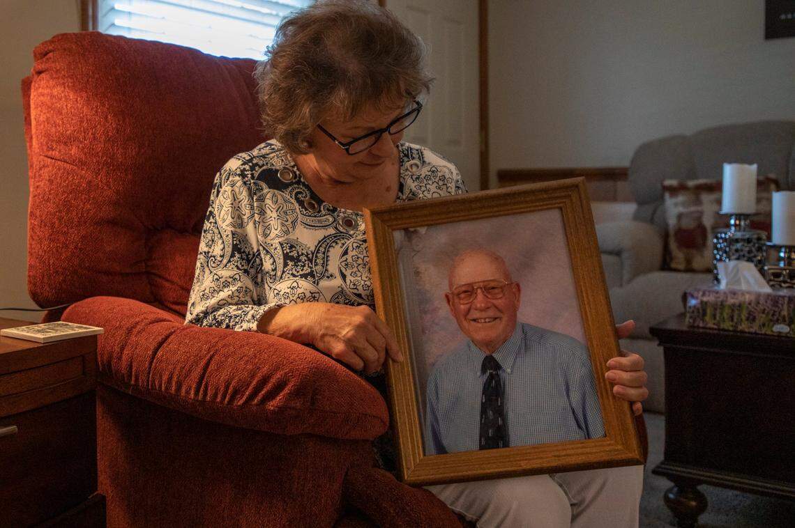 Deborah Williams sits for a portrait with a photograph of her father Roland Pittman who died three weeks after his evacuation on a boat from a Lumberton, N.C., nursing home by first responders and the Cajun Navy during Hurricane Florence and was then transferred to a home where Williams says he did not receive adequate care, on Friday, Oct. 11, 2019, in Lumberton, N.C.