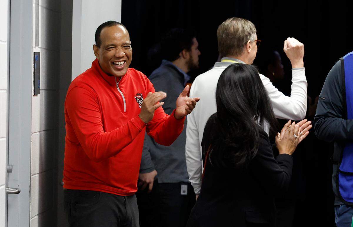 N.C. State head coach Kevin Keatts laughs as he heads towards the locker room after N.C. State’s 72-65 overtime victory over Virginia in the semifinals of the 2024 ACC Men’s Basketball Tournament at Capital One Arena in Washington, D.C., Friday, March 15, 2024.