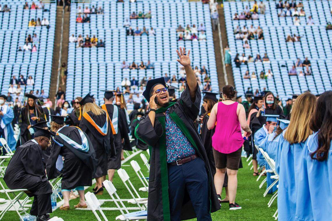 Andres Lopez waves to family in the stands prior to a commencement ceremony at UNC-Chapel Hill Friday, May 14, 2021.