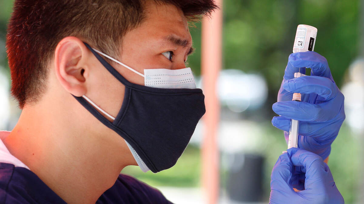 Jae Jung with inClinic RX prepares a Moderna COVID-19 vaccine shot during a free vaccine clinic in Moore Square in downtown Raleigh, N.C. Tuesday, May 4, 2021.