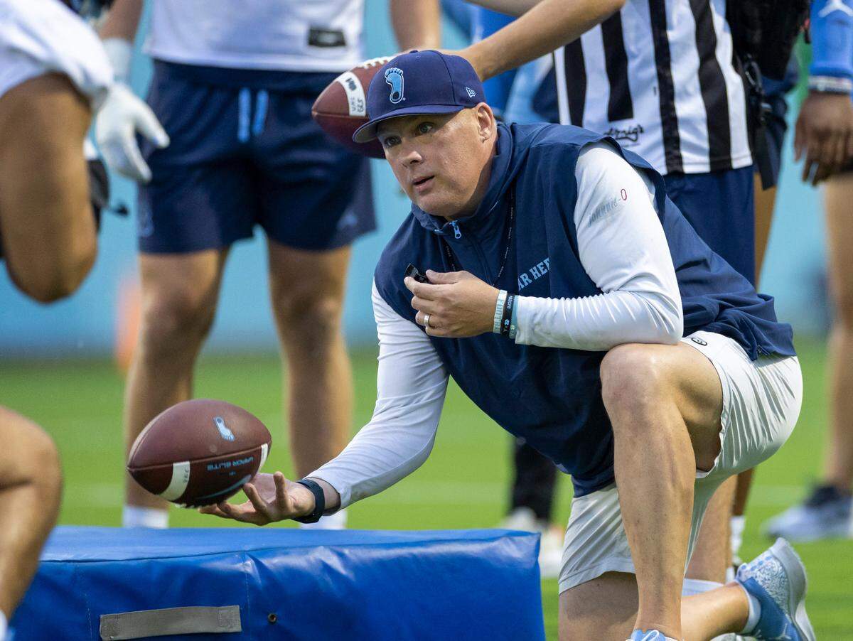 North Carolina defensive coordinator Geoff Collins works with his players during the Tar Heels’ first practice of the season on Monday, July 29, 2024 in Chapel Hill, N.C.