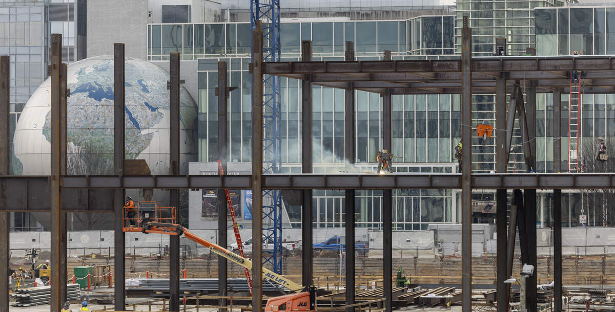 The skeletal steel frame of the North Carolina Education Campus at 116 W. Jones Street rises against the backdrop of the North Carolina Museum of Natural Sciences and the Raleigh skyline on Wednesday, November 26, 2025.  The $400 million project replaces the Administration Building and will house the University of North Carolina and the Community College Systems as wells as the Departments of Public Instruction and Commerce.