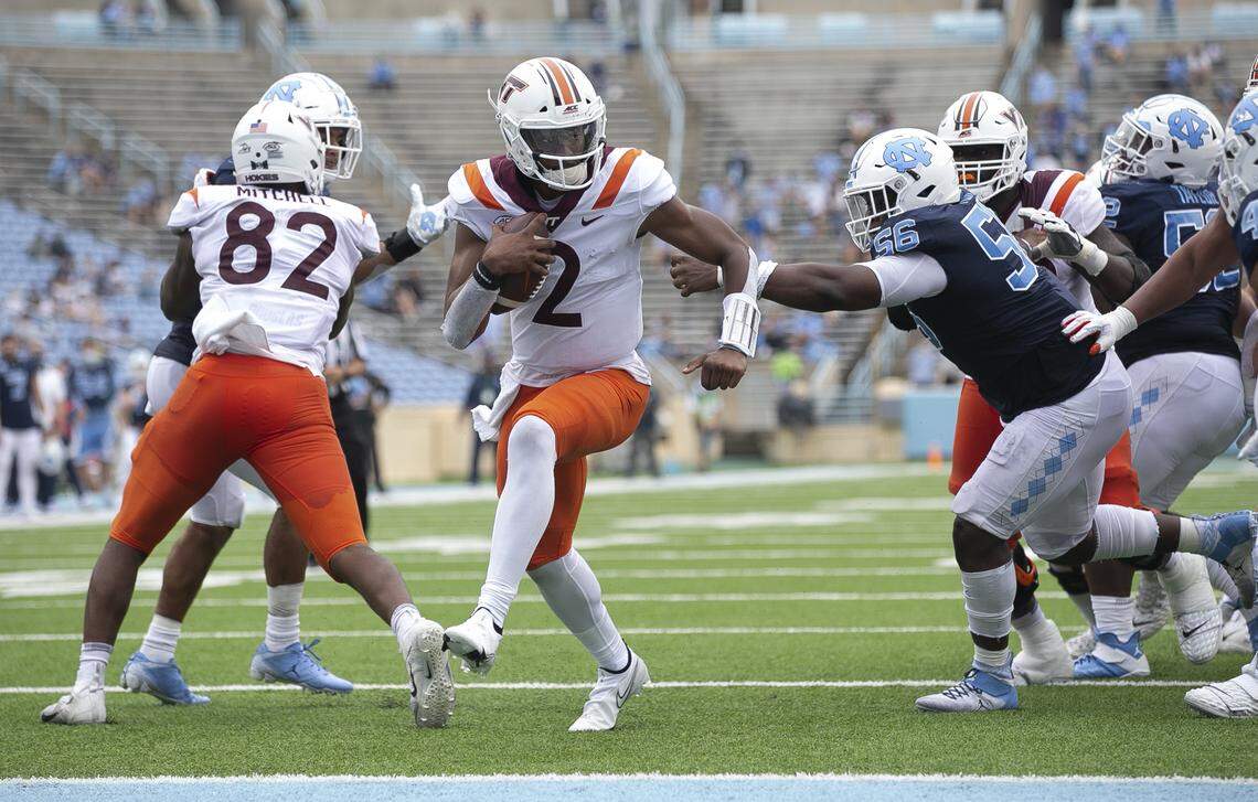 Virginia Tech quarterback Hendon Hooker (2) scores on North Carolina’s Tomari Fox (56) on a five-yard carry in the third quarter on Saturday, October 10, 2020 at Kenan Stadium in Chapel Hill, N.C.