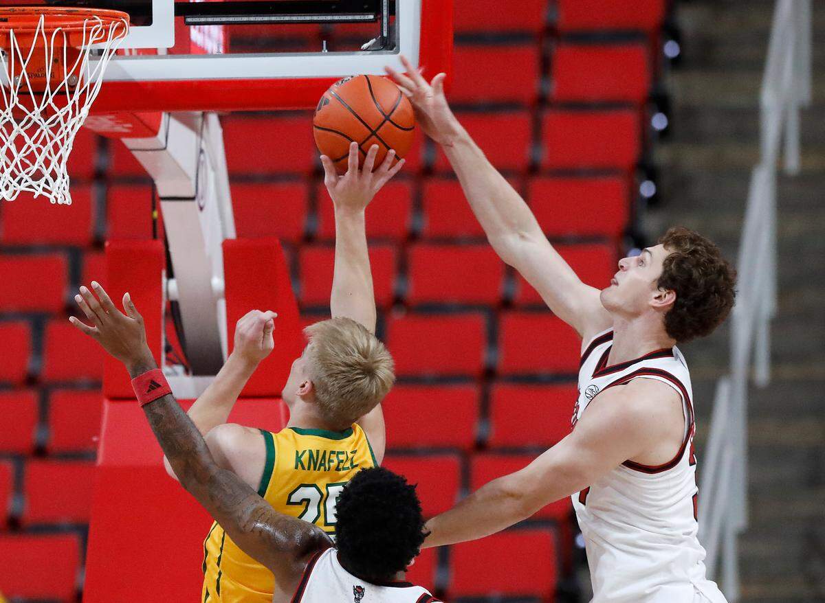 N.C. State’s Ben Middlebrooks blocks a shot by Lees-McRae’s Matthew Knafelz during the first half of the Wolfpack’s 79-75 exhibition win on Wednesday, Oct. 30, 2024, at the Lenovo Center.