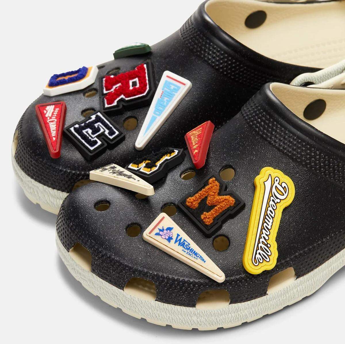 The Dreamville x Crocs Varsity Clog features a varsity letter jacket and has six custom charms with pennants celebrating the hometowns of each of the artists on the Dreamville Records label.