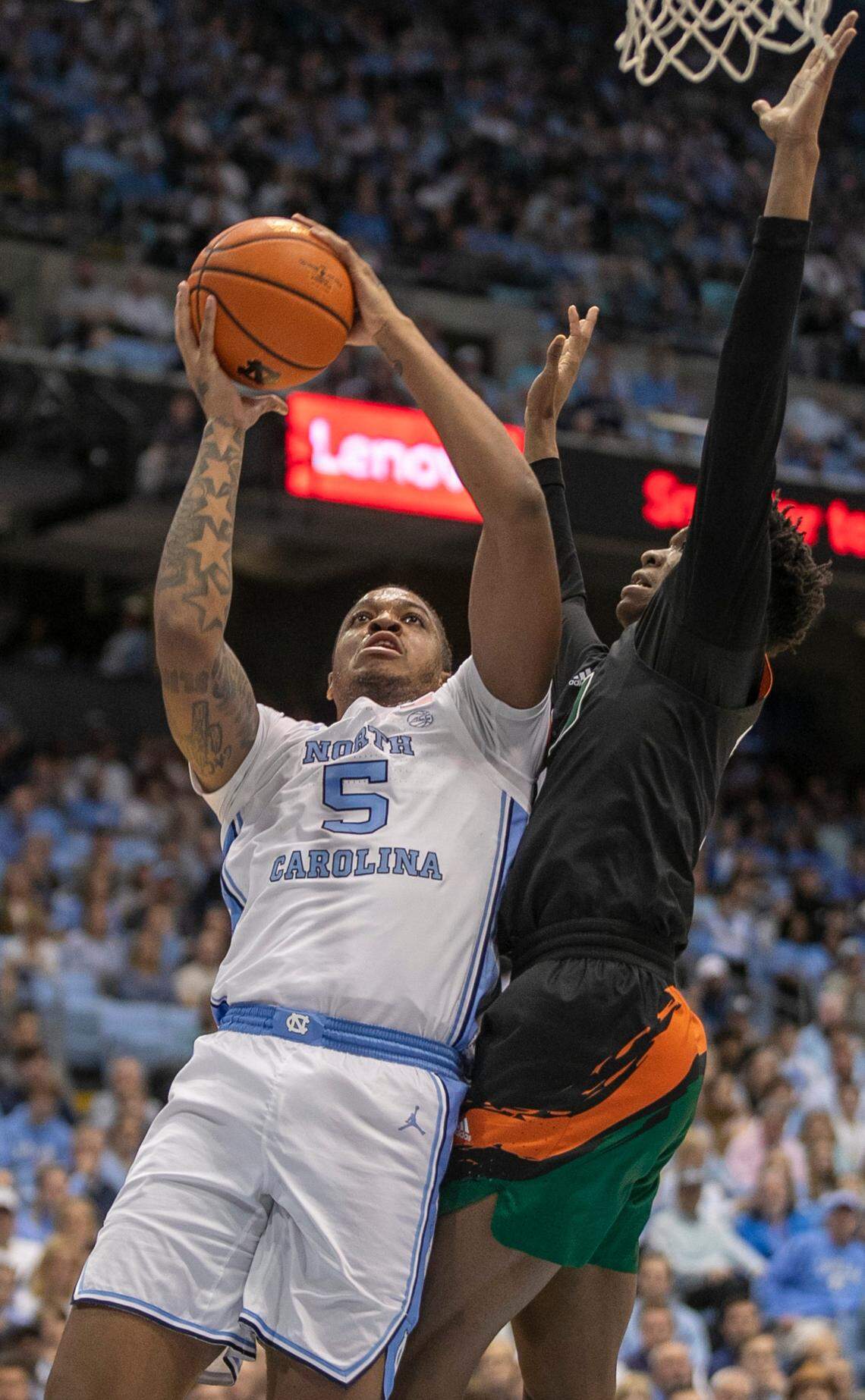 North Carolina’s Armando Bacot (5) muscles his way to the basket against Miami’s Anthony Walker (1) in the first half on Monday, February 13, 2023 at the Smith Center in Chapel Hill, N.C.