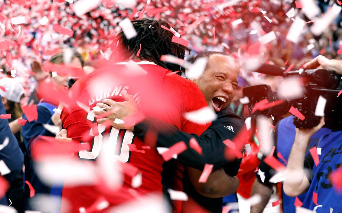 N.C. State’s head coach Kevin Keatts hugs DJ Burns Jr. (30) after N.C. State’s 84-76 victory over UNC in the championship game of the 2024 ACC Men’s Basketball Tournament at Capital One Arena in Washington, D.C., Saturday, March 16, 2024.