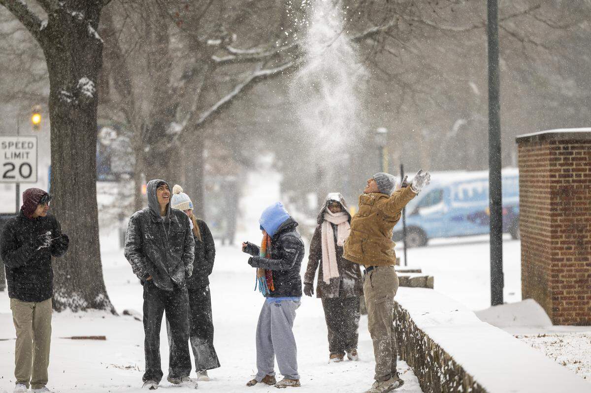 UNC-Chapel Hill students play in the snow along Franklin Street in Chapel Hill on Saturday afternoon, Jan. 31, 2026, as a winter storm brings snow and freezing temperatures to the region.
