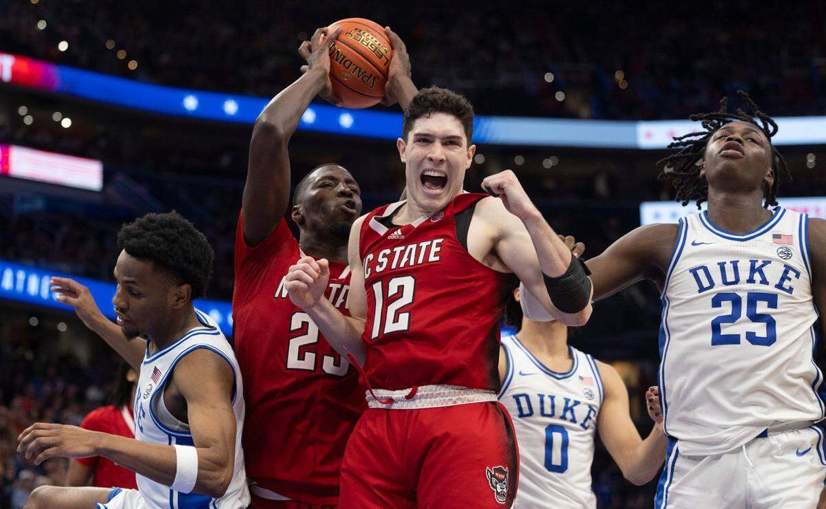 N.C. State’s Mohamed Diarra (23) secures the final defensive rebound as the clock expires, and teammate Michael O’Connell (12) begins the celebration of the Wolfpack’s 74-69 victory over Duke in the quarterfinals of the ACC Men’s Basketball Tournament at Capitol One Arena on Wednesday, March 13, 2024 in Washington, D.C.