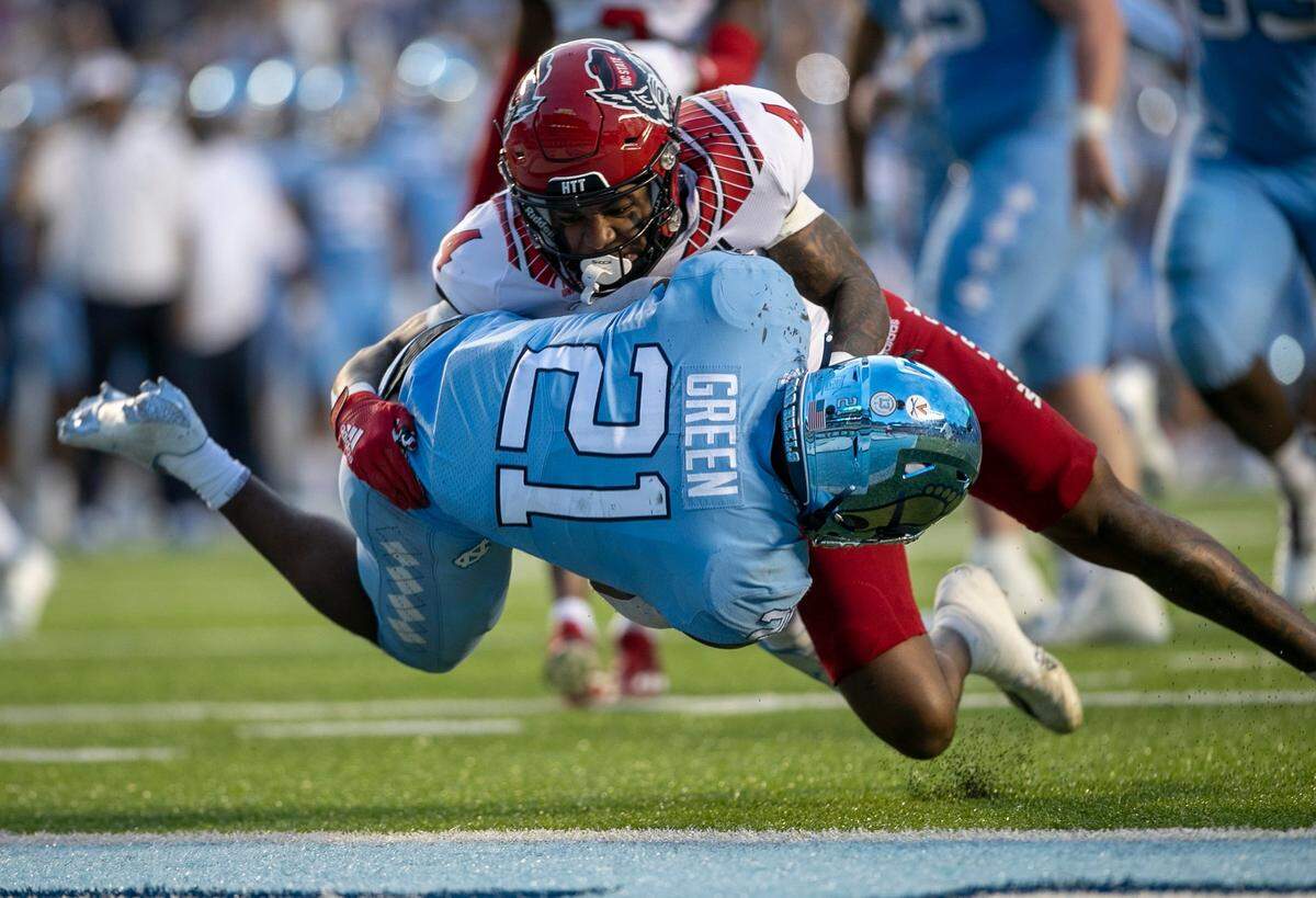 North Carolina’s Elijah Green (21) scores on a nine yard carry to cut the N.C. State lead to 14-10 in the second quarter on Friday, November 25, 2022 at Kenan Stadium in Chapel Hill, N.C.