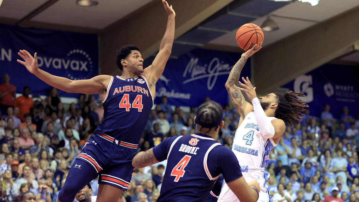 North Carolina Tar Heels guard RJ Davis (4) shoots as Auburn Tigers center Dylan Cardwell (44) defends during the first half of their game in the Maui Invitational Tuesday, Nov. 26, 2024.